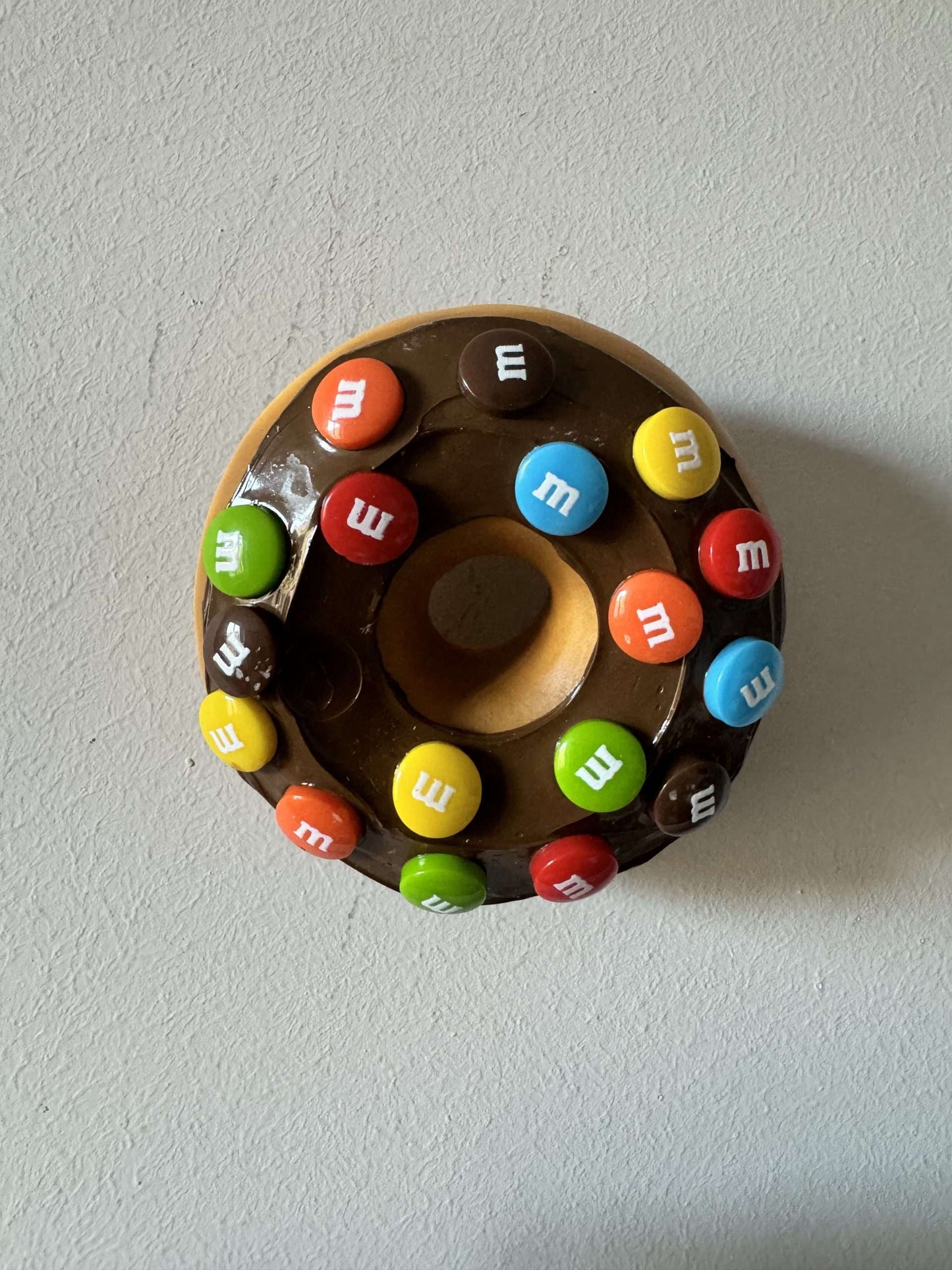 Donut with chocolate icing and M&Ms