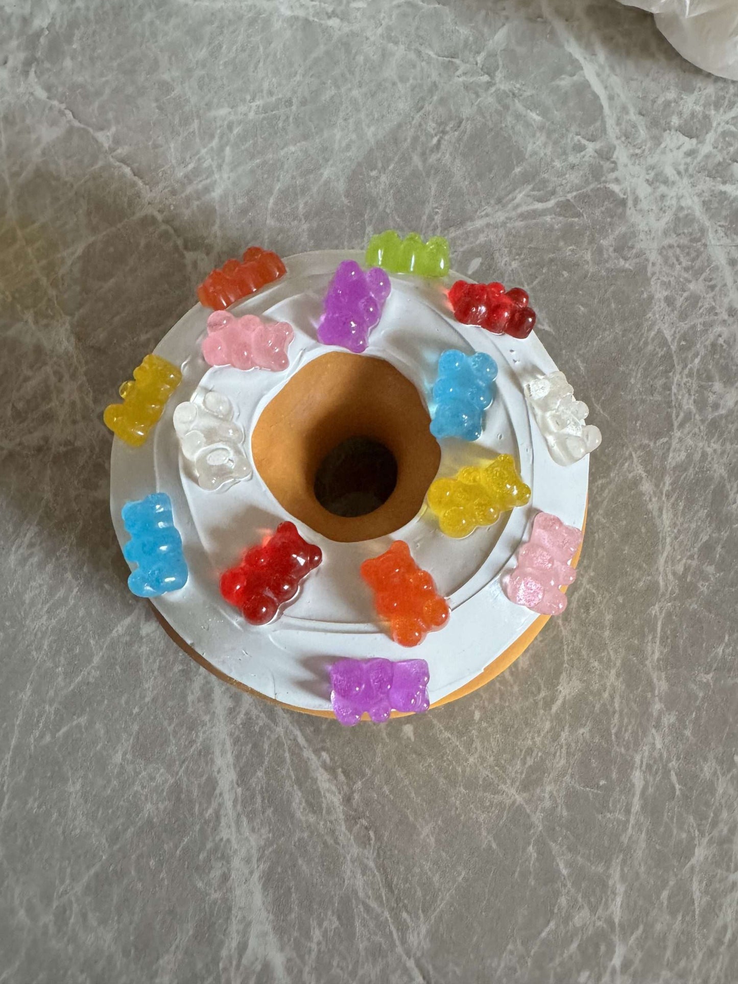 Donut with white icing and colorful gummy bears