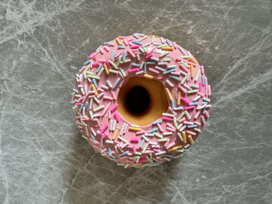 Donut with violet icing and colored sprinkles