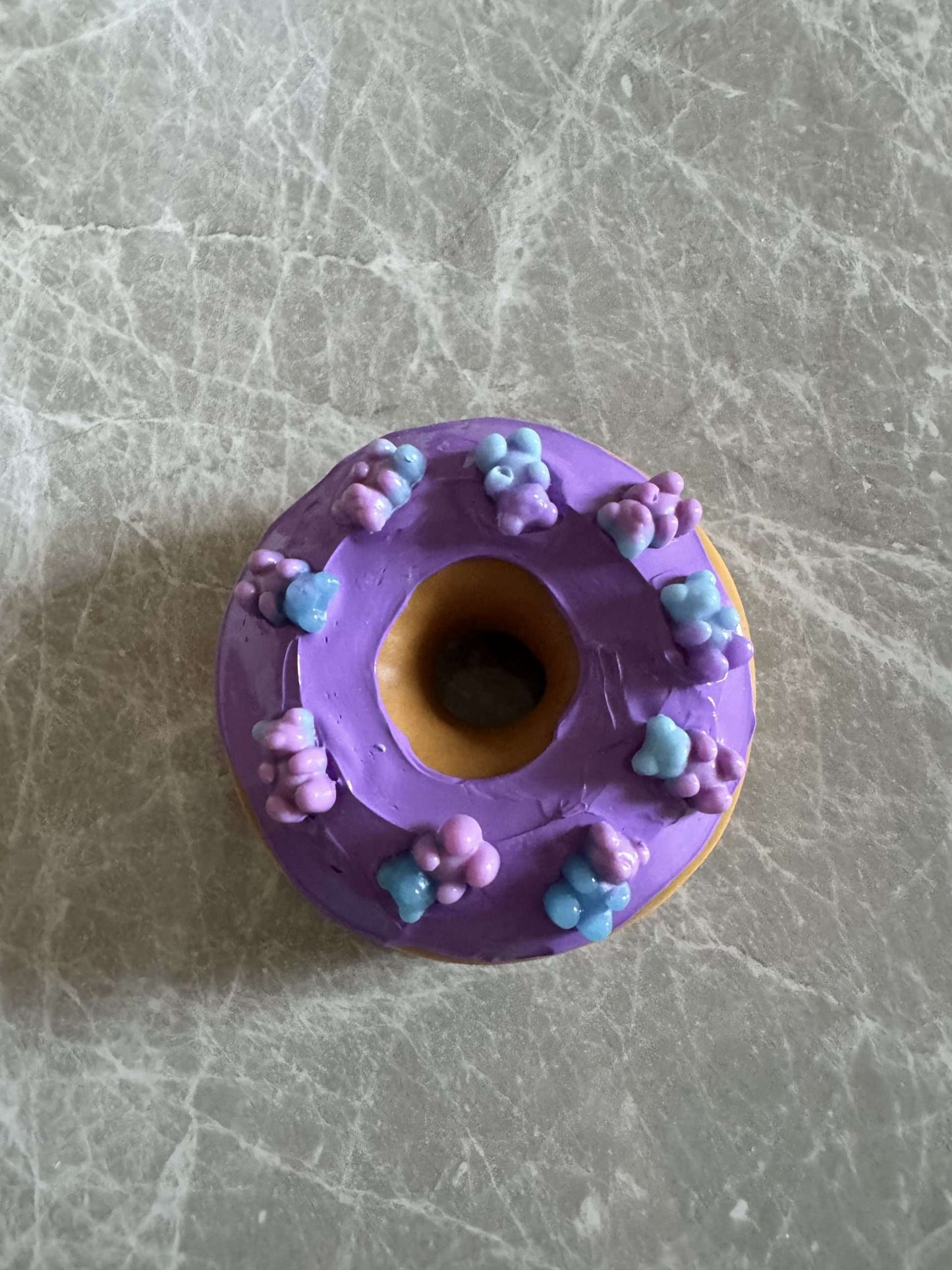 Donut with lilac icing and bear candies
