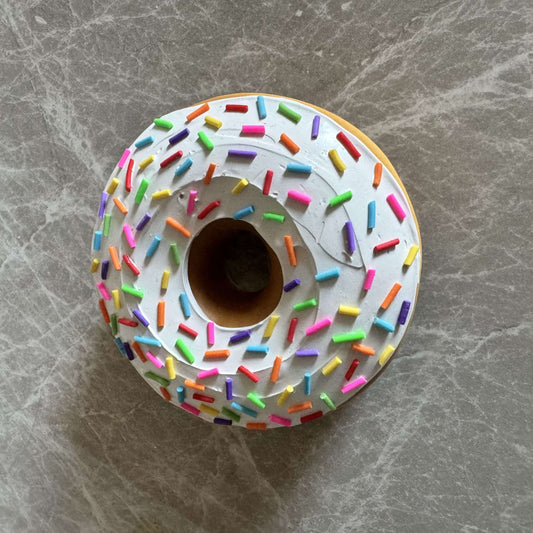 Donut with white icing and colored sprinkles