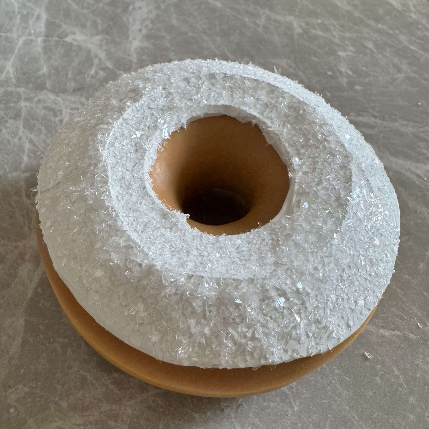 Donut with white icing and coconut powder